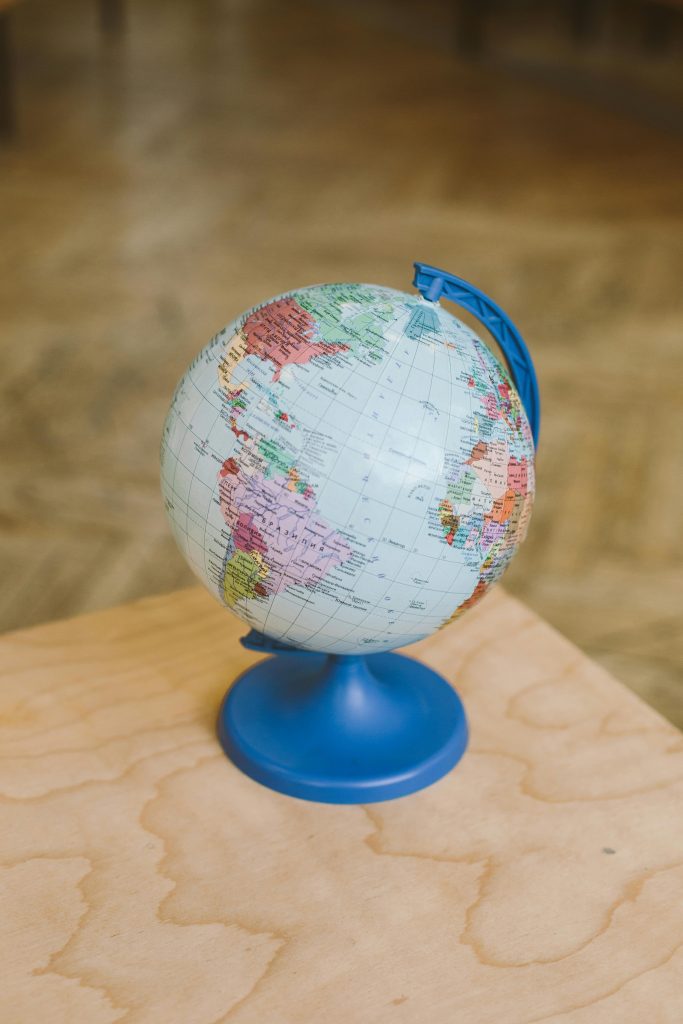A globe on a wooden table indoors, symbolizing education and geography.